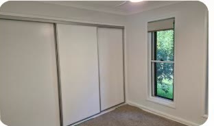 Bedroom interior painting project with neutral walls and clean trim in Brisbane